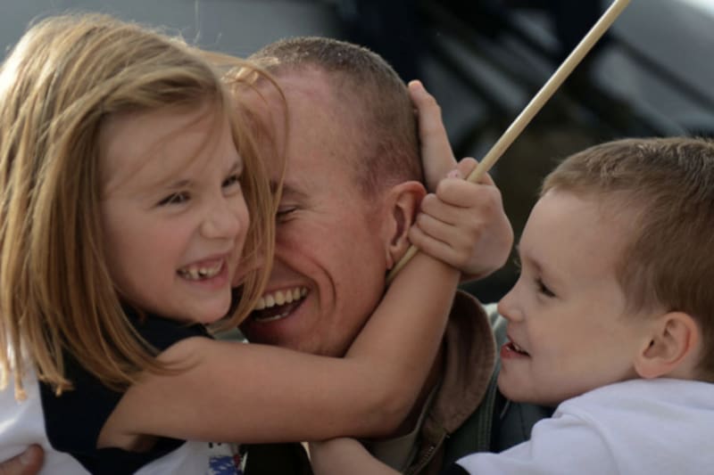 Man hugging his daughter and son